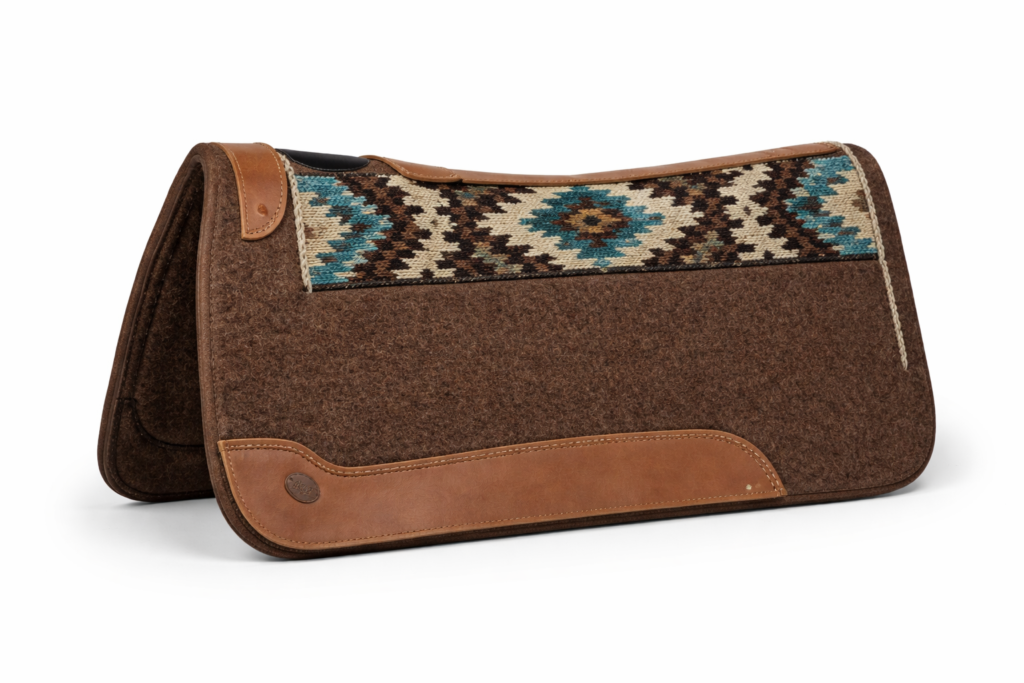A thick brown wool felt Western saddle pad with a decorative geometric patterned top and leather wear leathers.